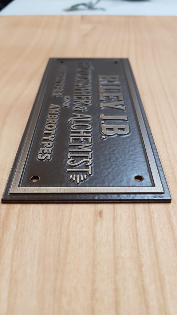 Cast bronze plaque with antique oxide finish