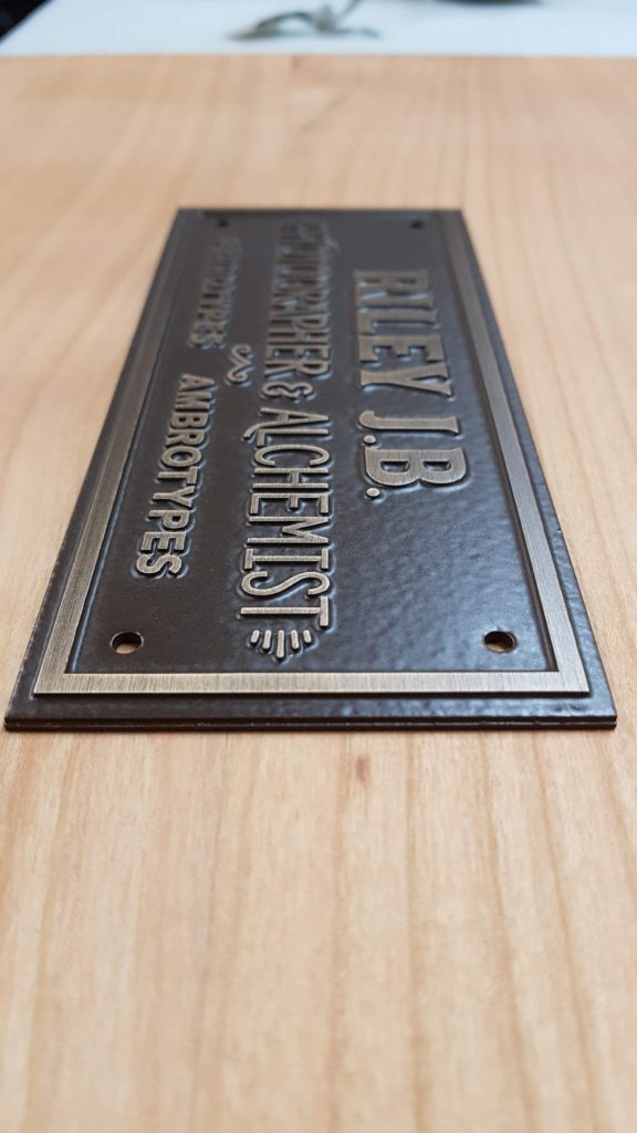 Cast bronze plaque with antique oxide finish